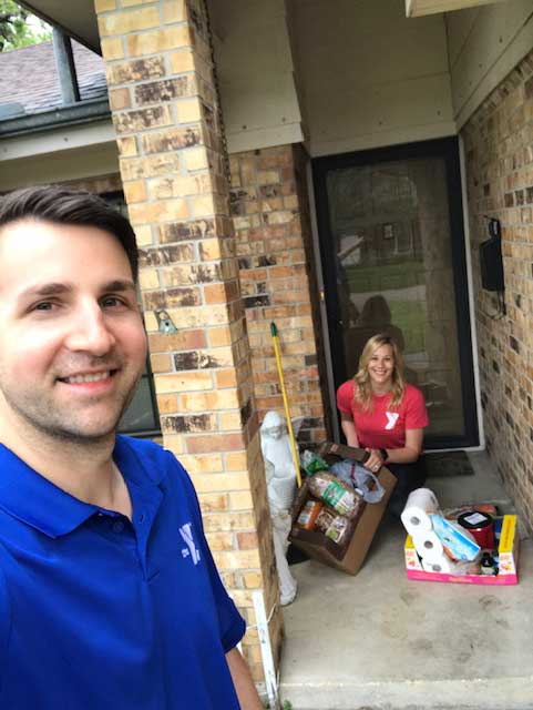 District Executive Director of the J.E.R. Chilton YMCA at Rockwall Clint Elliott and Membership Director Jocelyn Craig deliver the groceries to Sue. 