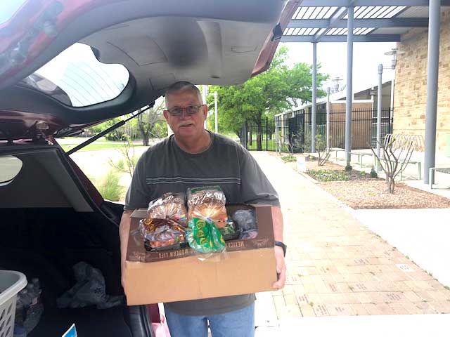 Jim Turner delivers a box full of groceries for Sue to the J.E.R. Chilton YMCA at Rockwall.