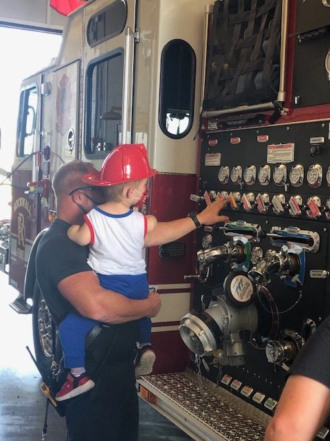 Easton Knight looks at the gadgets on a fire engine at Rockwall Fire Station #2.